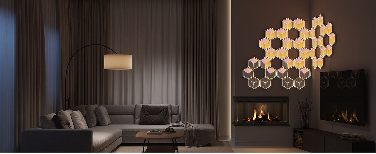 Hexagon LED wall panels with rainbow RGB glow arranged above fireplace