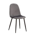 Grey velvet dining chair with black metal legs, rounded back and cushioned seat