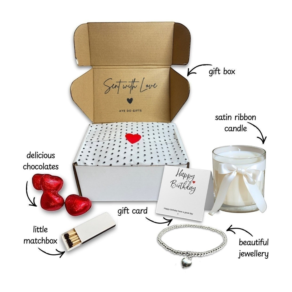 Gift box set with satin-ribbon candle, red chocolates, heart necklace, and matchbox
