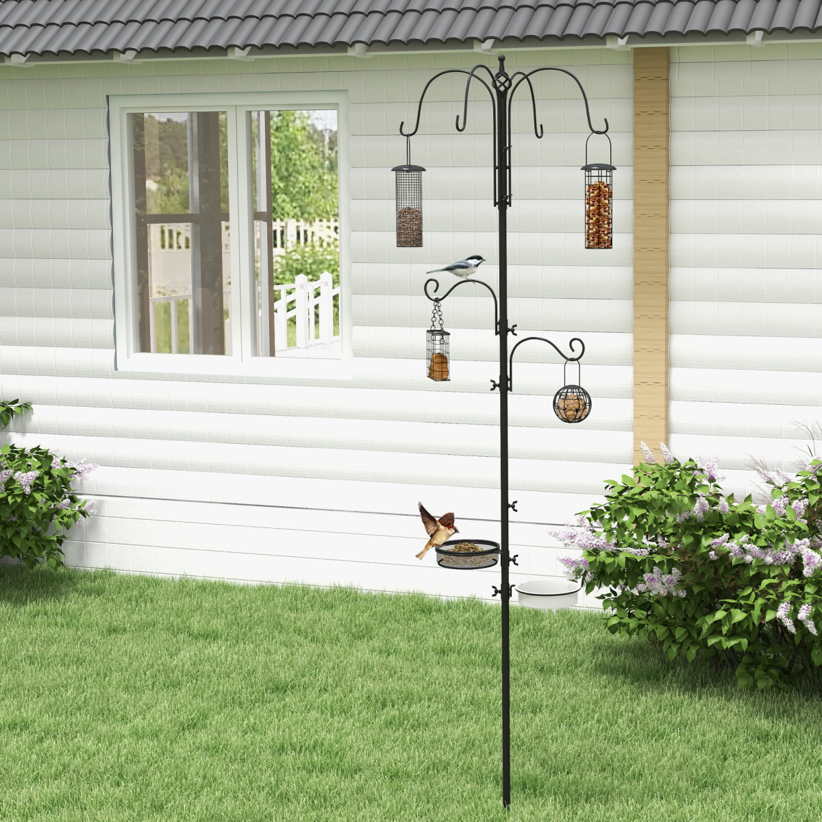Black outdoor bird feeding station with hanging seed feeders and tray on post