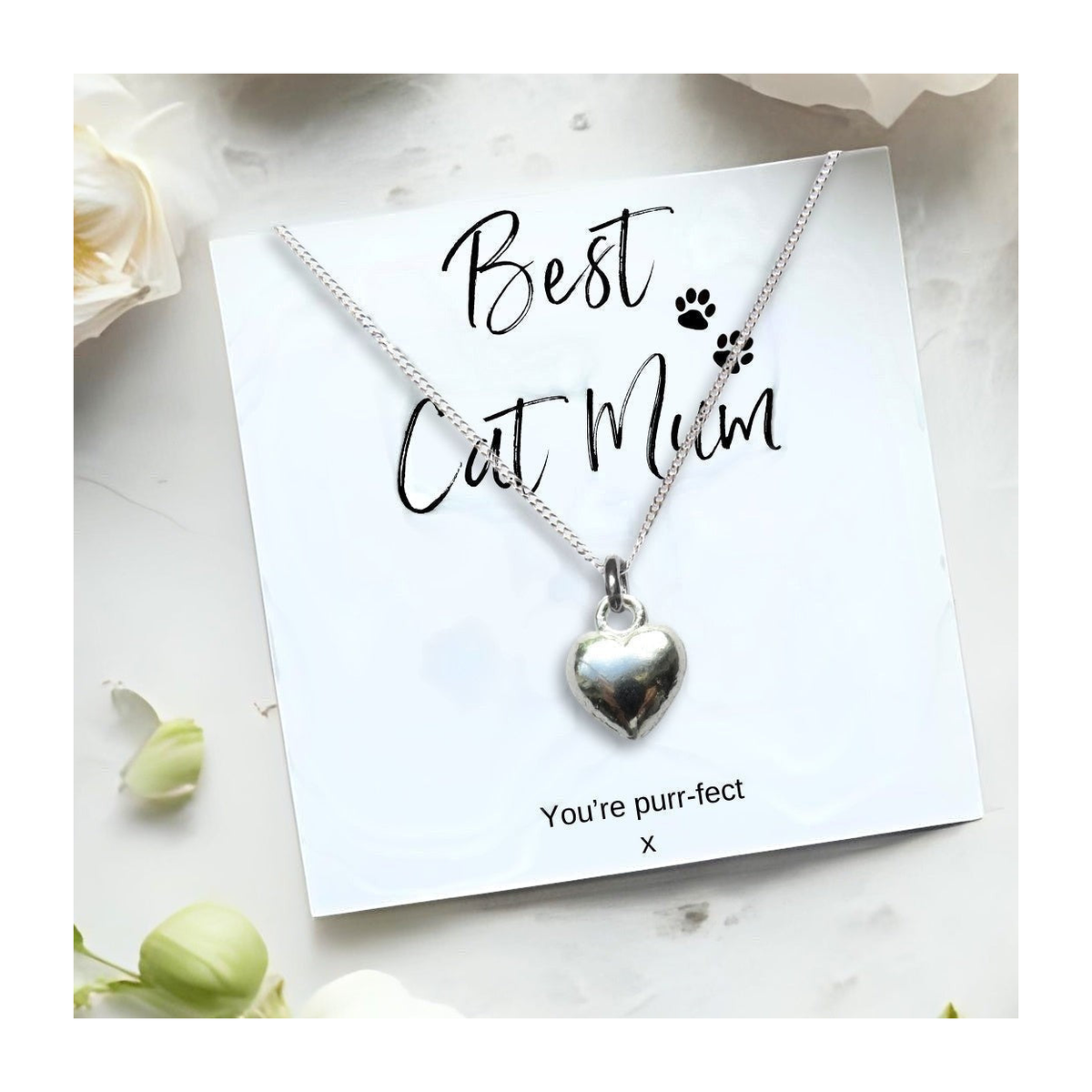 Silver heart pendant necklace with chain on a white gift card