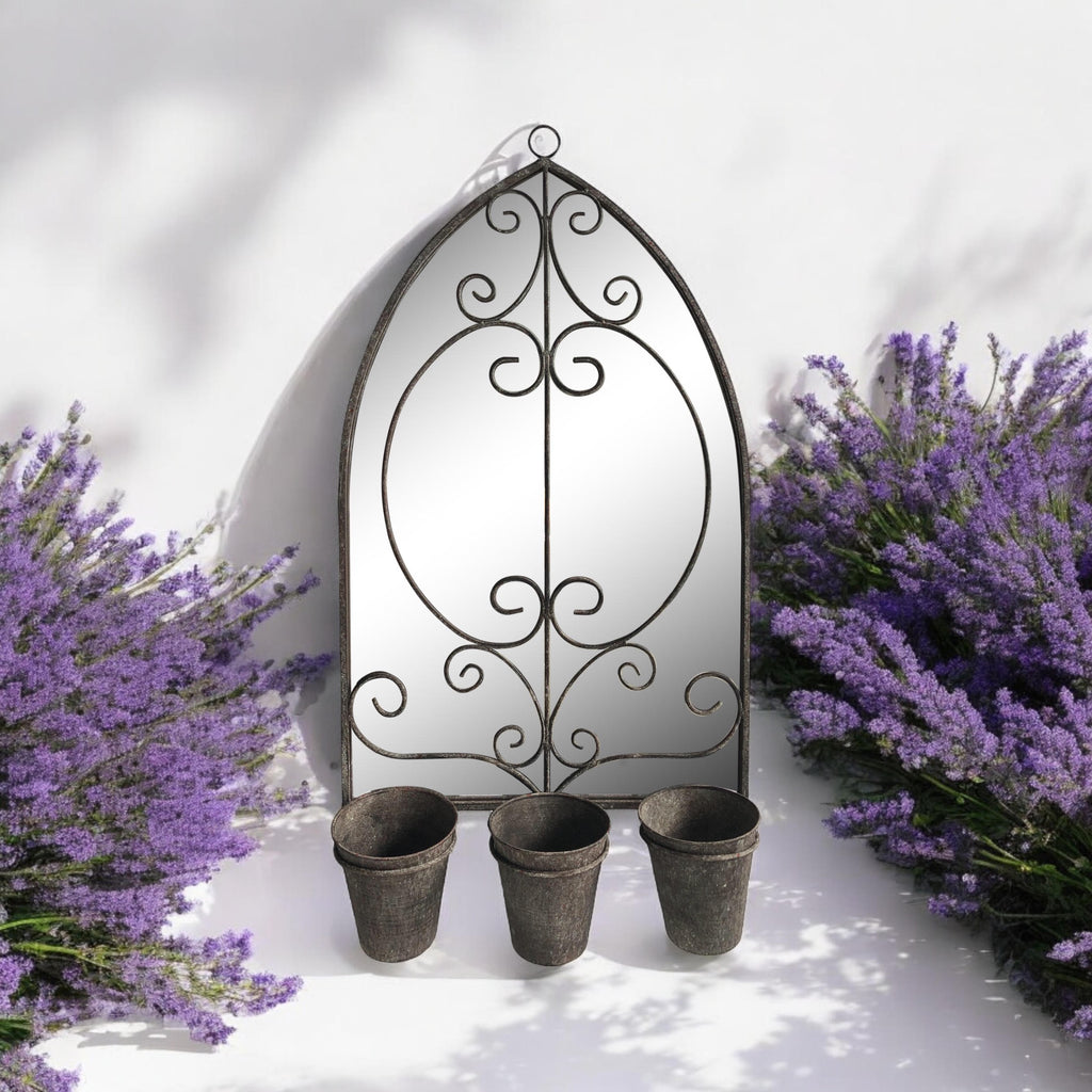 Arched metal wall mirror with hanging loop, scrollwork center, and three planter cups below