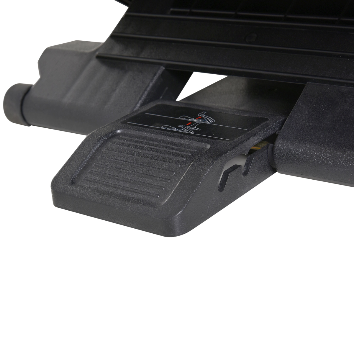 Under-desk footrest underside showing adjustment mechanism and textured pedal