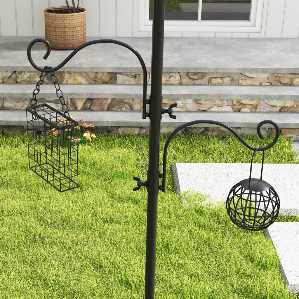 Black bird feeding station post with hanging wire feeder and hanging suet basket