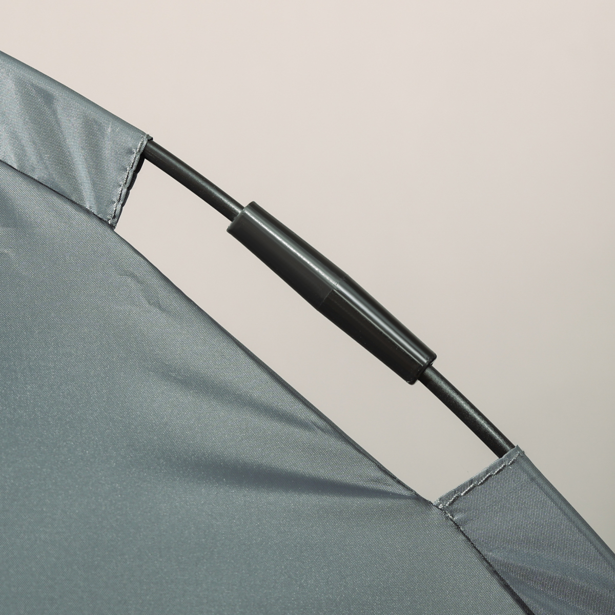 Grey canopy fabric edge with black support tube on elevated dog bed