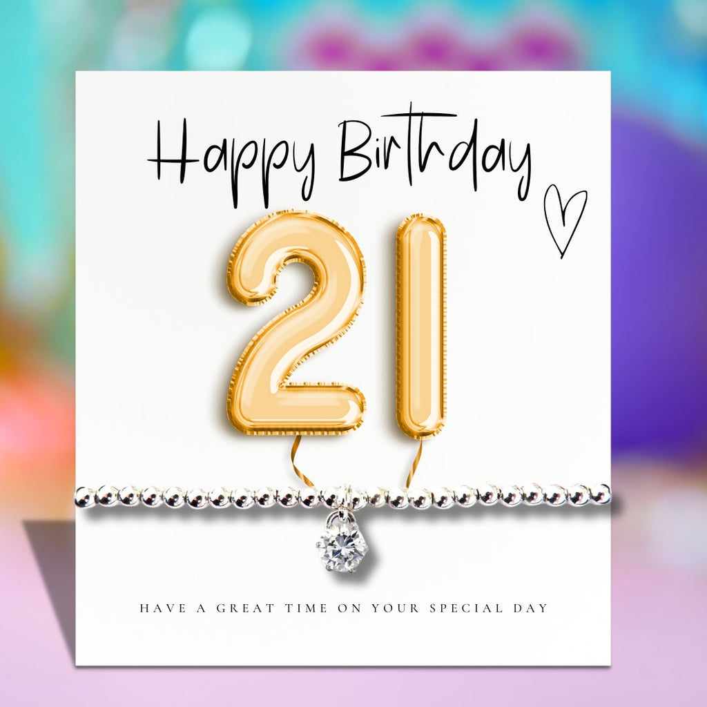 Greeting card with gold 21 balloon and silver beaded bracelet charm