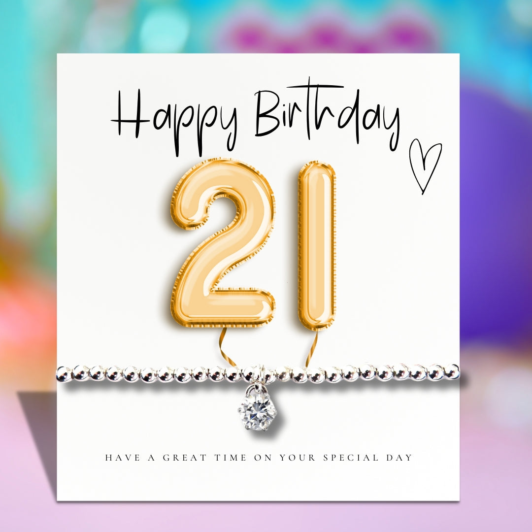 Greeting card with gold 21 balloon and silver beaded bracelet charm
