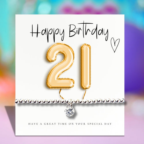 Greeting card with gold 21 balloon and silver beaded bracelet charm