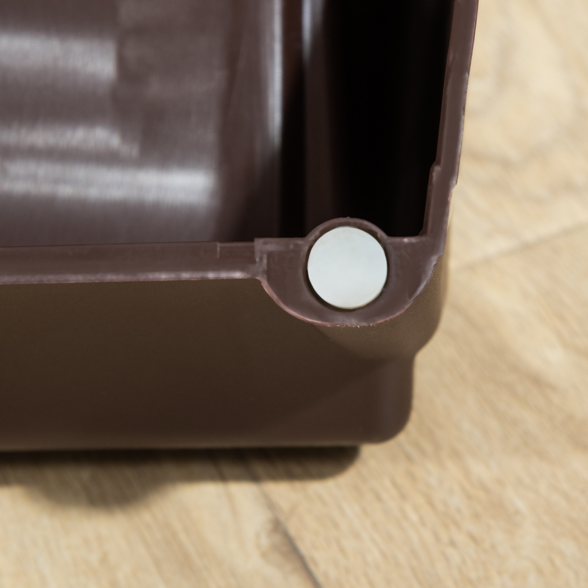 Brown foldable pet stairs close-up of locking pin on the side panel
