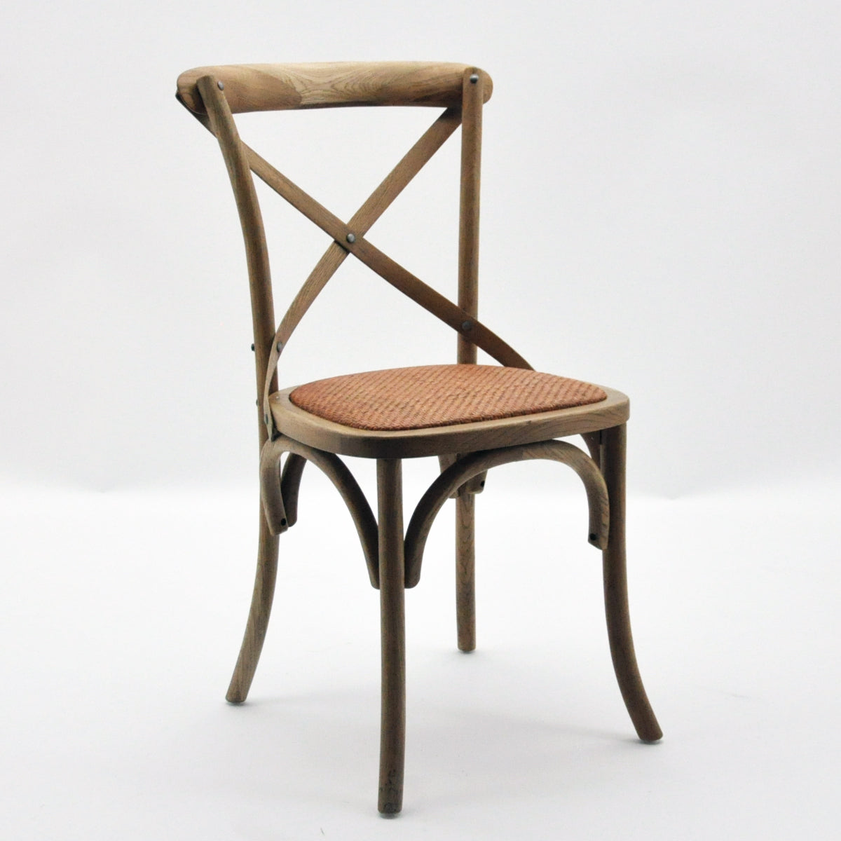 Cross-back dining chair with woven seat and curved wooden legs, warm oak finish.