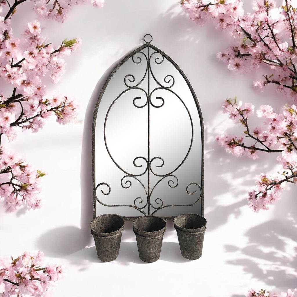 Vintage arched metal wall mirror with scroll frame and three planter cups underneath