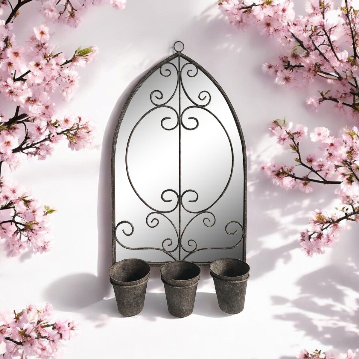 Vintage arched metal wall mirror with scroll frame and three planter cups underneath