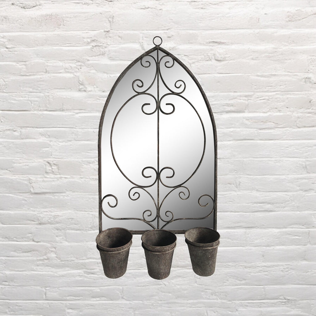 Arched metal wall mirror with scrollwork and three planter cups at the bottom