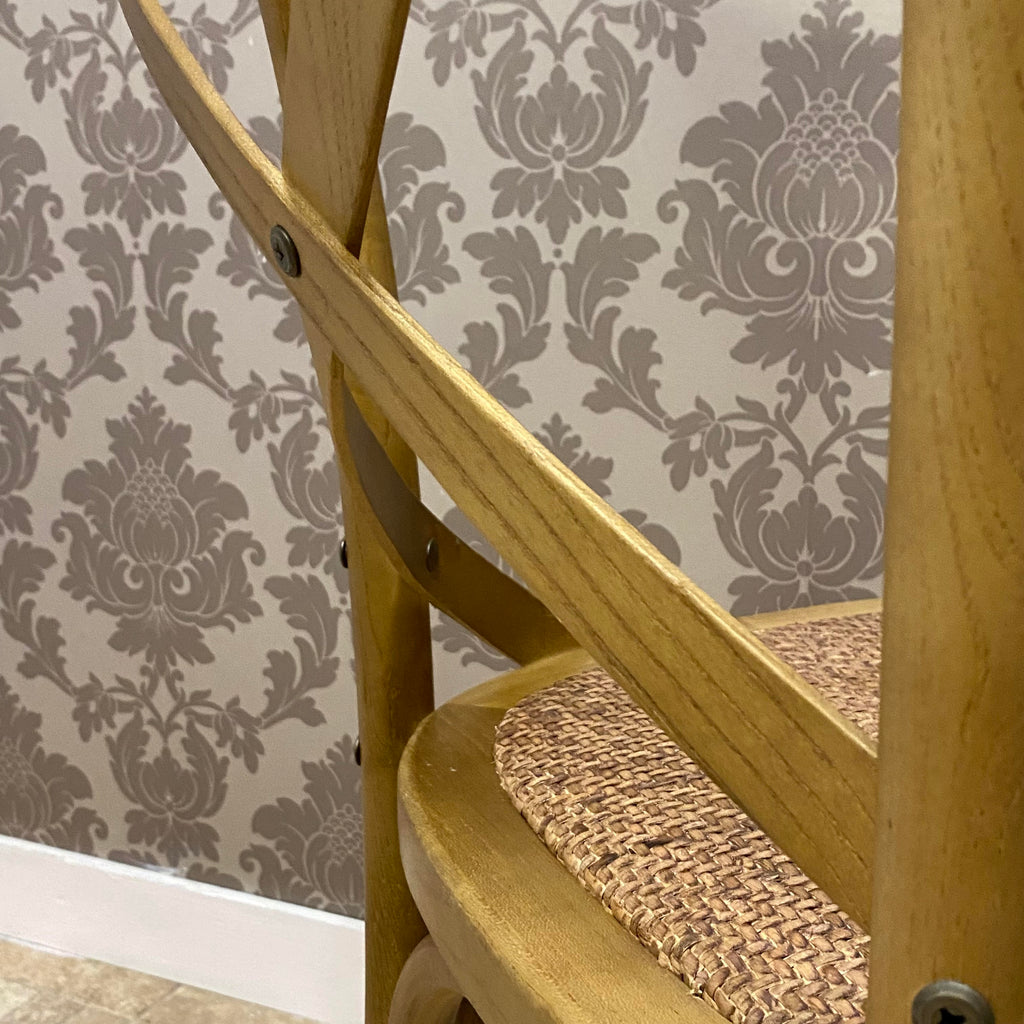 Oak dining chair side brace and woven seat, rounded arms with metal screws.