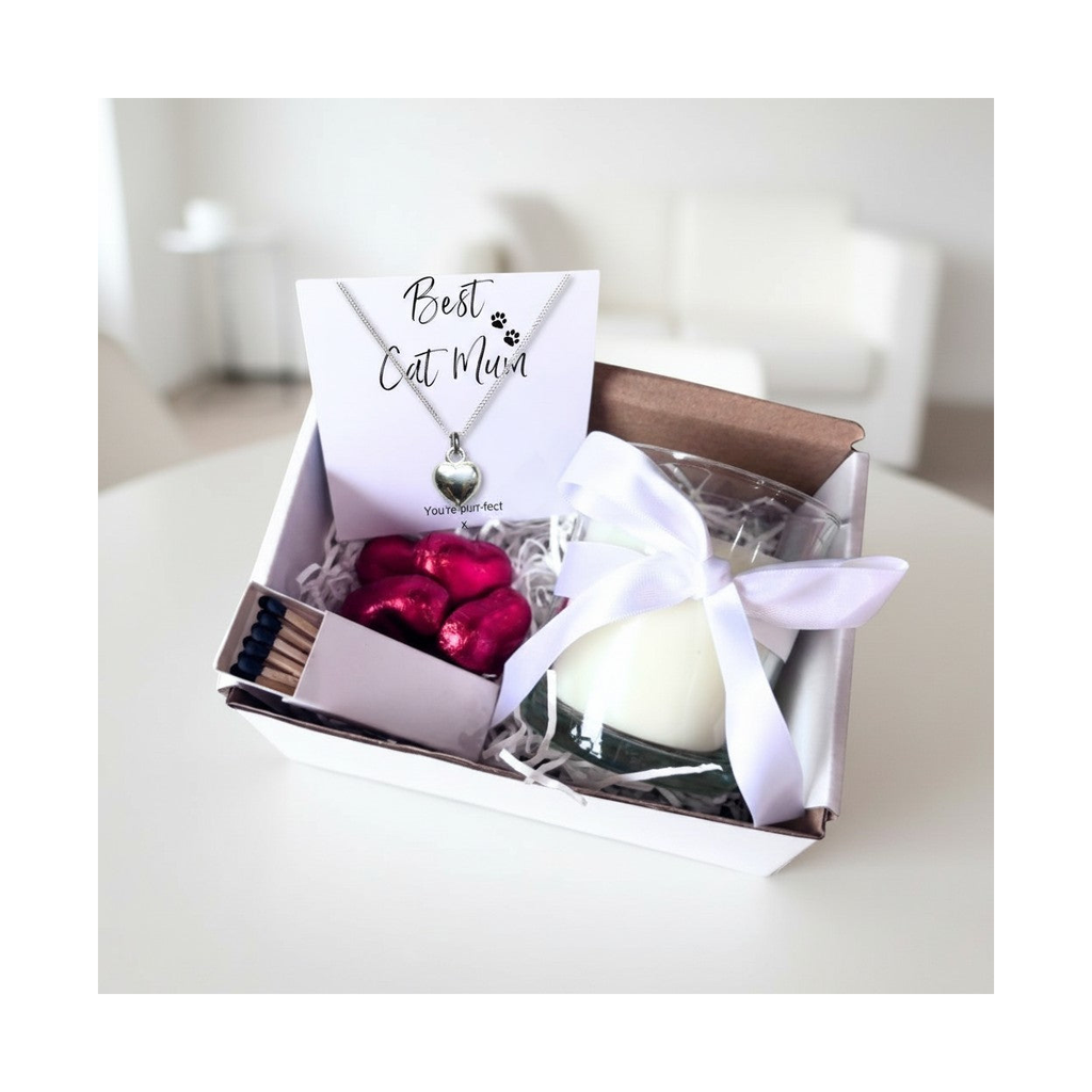 Cat gift hamper with heart necklace, white candle, red chocolates, and matchbox in box